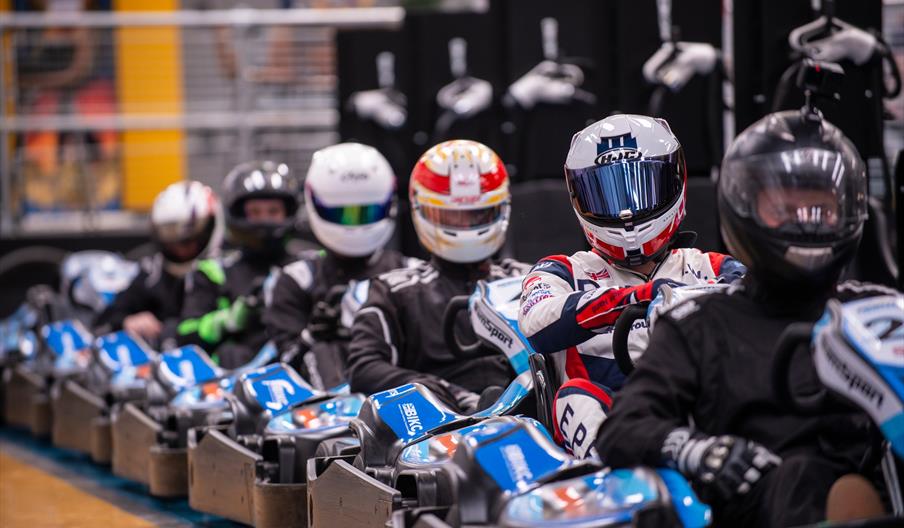 A line of racers in go-karts ready to race.
