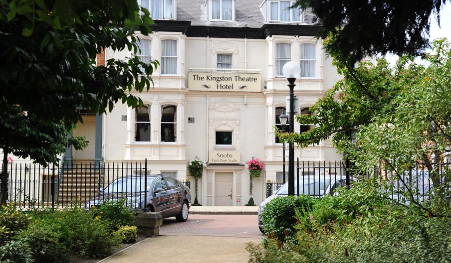 The main entrance to the Hotel framed by the planting in Kingston Square.