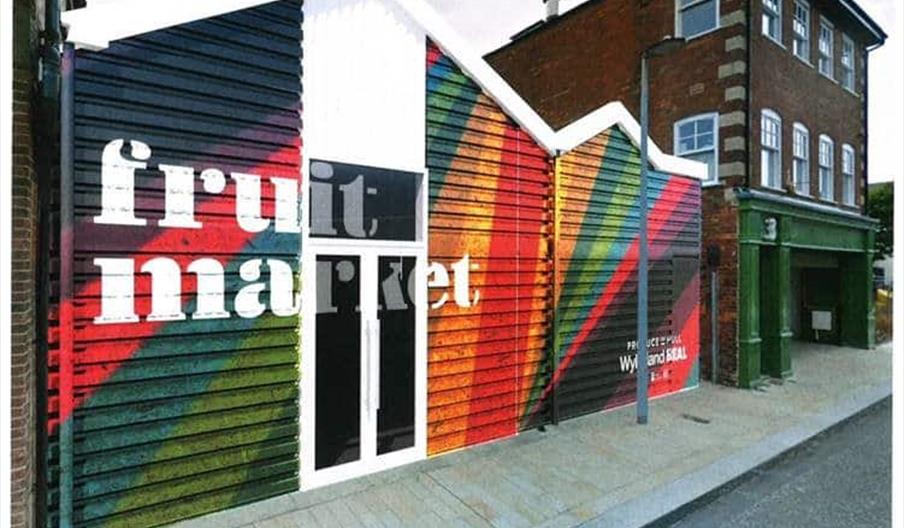 The front of the Space building, in Pier Street in Hull. A multicoloured front with the words 'Fruit Market' sprayed over it in white.