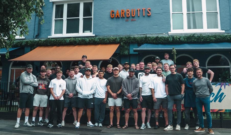 Group photo outside Garbutts Princes Avenue Hull , in front of the restaurant’s terrace and distinctive blue exterior.