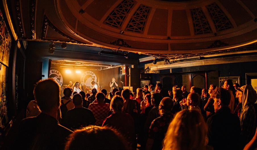 Audience gathered inside Polar Bear Music Club in Hull, watching a live band perform on stage beneath the venue's distinctive domed ceiling.