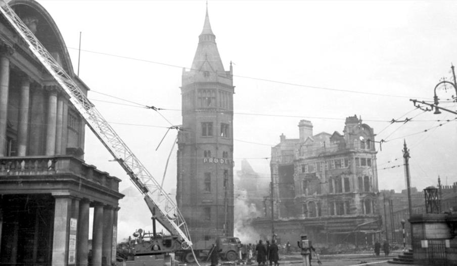 Hull's Queen Victoria Square in the 1940's, including a fire engine ladder leading to the roof of Hull City Hall, several soldiers and civilians movin