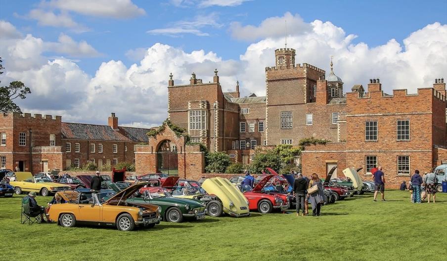 Burton Constable Hall with classic cars parked outside