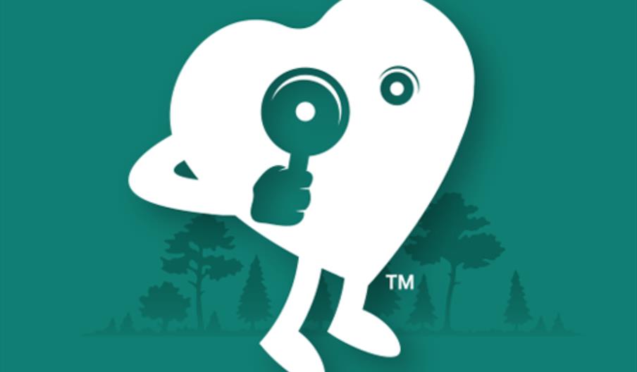 A logo showing a cartoon heart with arms and legs holding a magnifying glass. In the background, cutouts of trees can be seen.