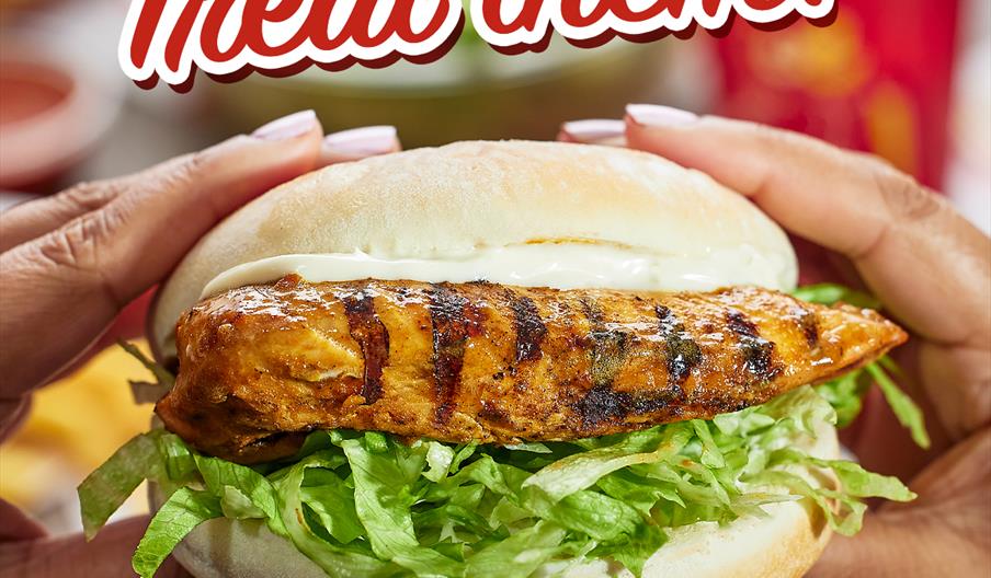 A close-up of hands holding a grilled chicken sandwich with lettuce and mayonnaise in a bun, with the words "Treat them!" above and the Pepe's restaur
