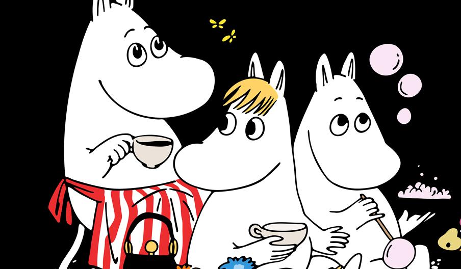 Illustration of three Moomin characters sitting together; one drinks tea while wearing a red-and-white striped apron, another holds a teacup, and the