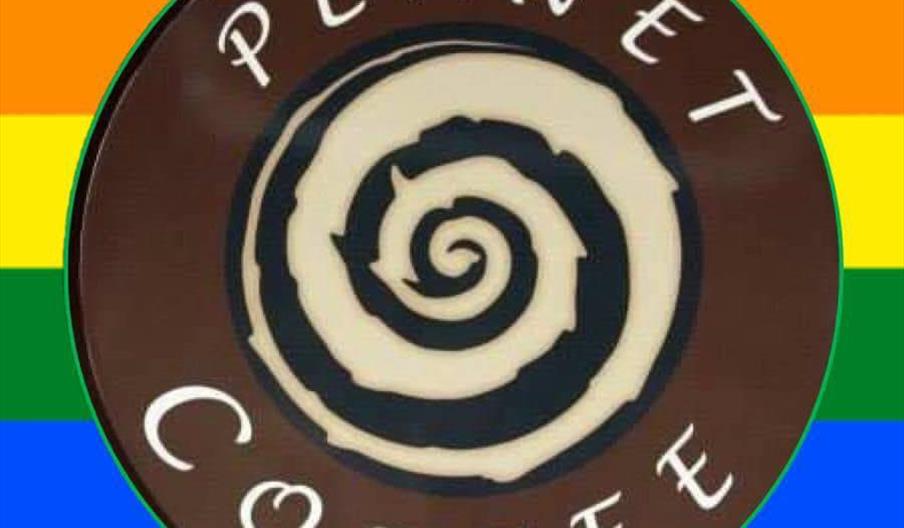 The image shows a circular logo with the words "Planet Coffee" and a spiral design in the center, placed against a background of horizontal rainbow st