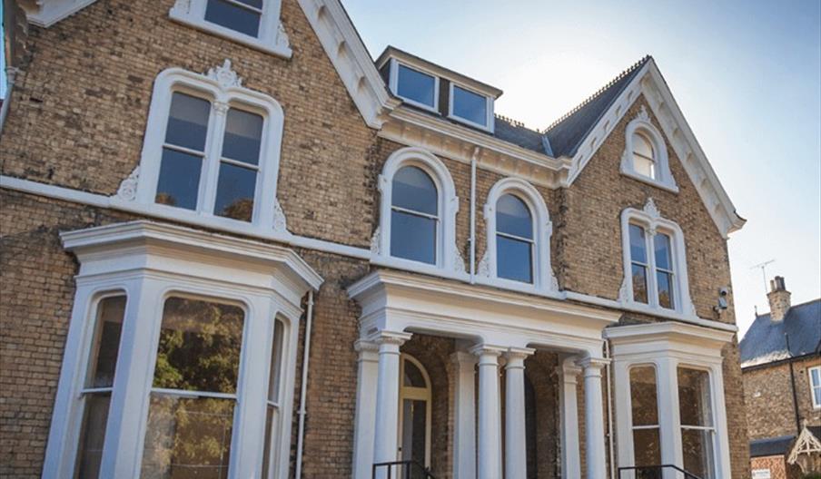 Ouside of victorian building with steps to main entrance.