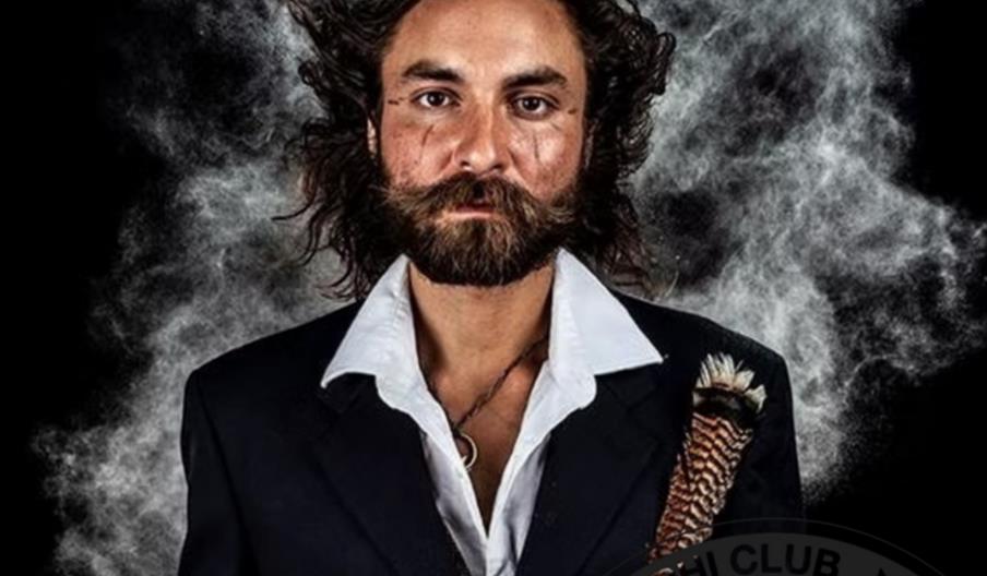 Concert poster for Arthur Buezo with Rivers Johansson, featuring a man with long curly hair and a beard wearing a black suit and white shirt, with a f