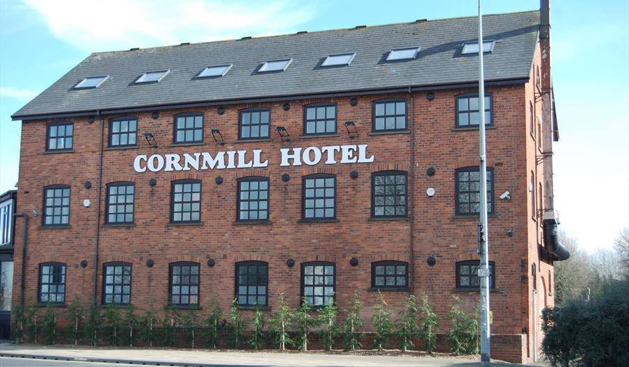 Exterior image of the hotel, a large red brick building.
