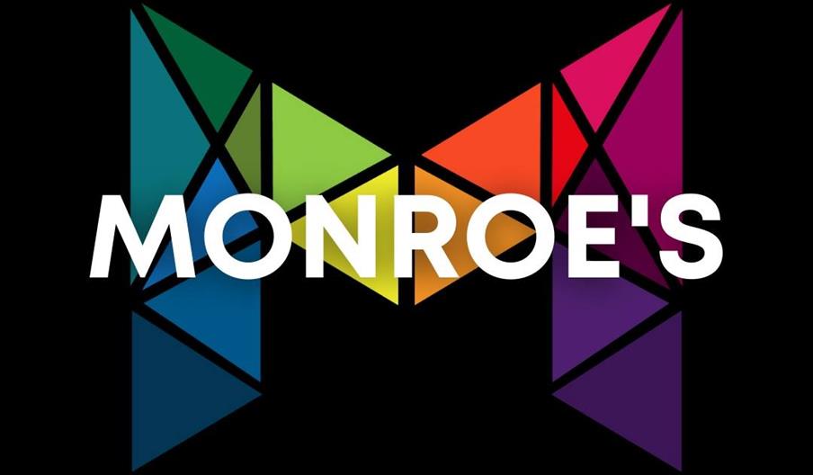 A large, geometric letter "M" made up of colorful, triangular shapes on a black background, with the word "MONROE'S" in bold white letters overlaid ac
