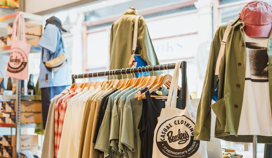 Interior of Beasley's clothing store in Hull, featuring a display of casual menswear on clothing rails and mannequins. Shirts, jackets, and accessorie