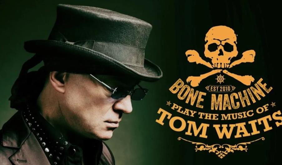 A man in a dark hat and sunglasses faces left against a green background. To the right, yellow text with a skull and crossbones logo reads, "Bone Mach