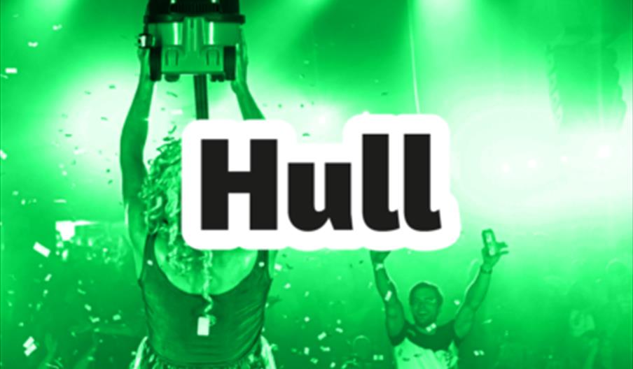 A person on stage holds a prize vacuum cleaner above their head as green lights and confetti fill the crowded room. The text reads "Bongo's Bingo Hull