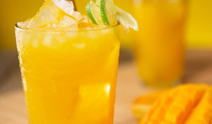 A table covered in different breads and a smorgasbord of deli meats.