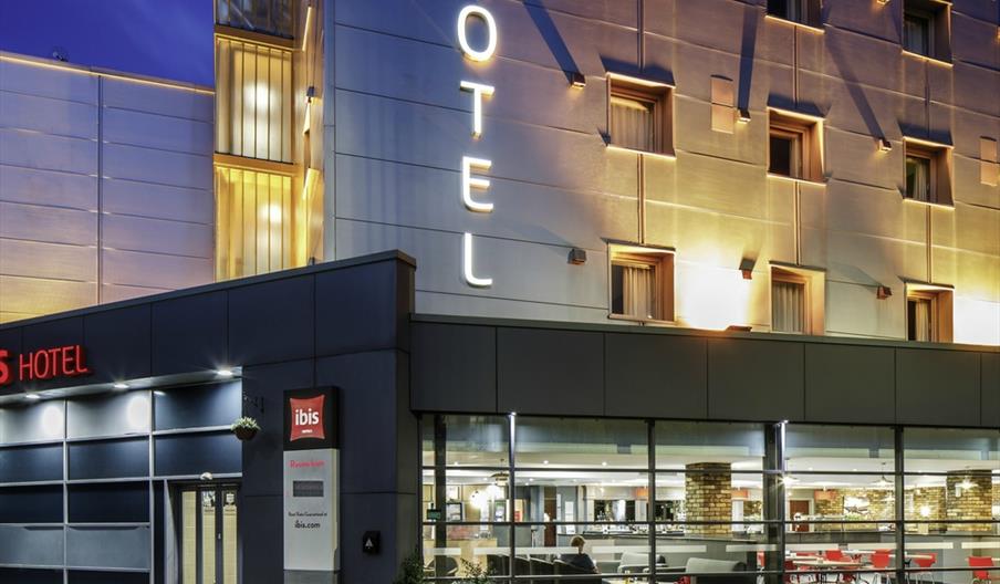 Outside view of hotel, illuminated at night