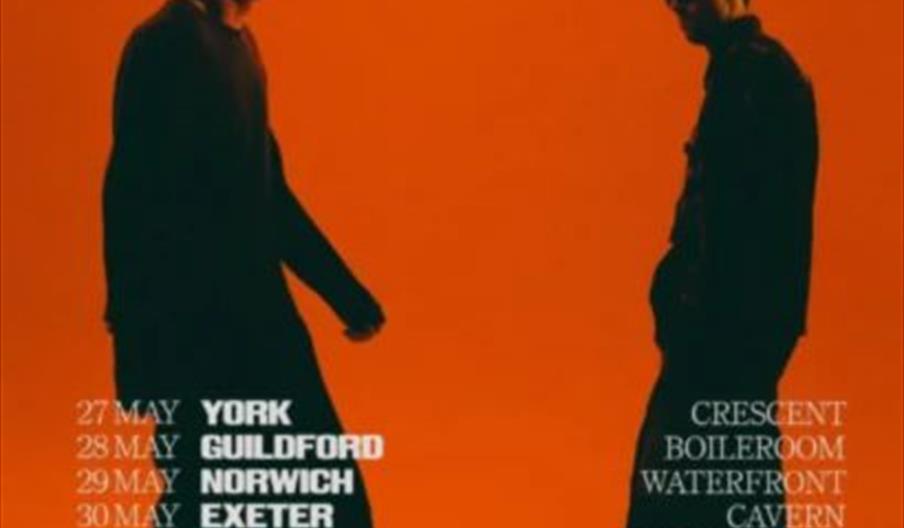 Two men in silhouette stand facing each other against an orange background. Large white text at the top reads "CQ Wrestling UK Tour 2026," with a list