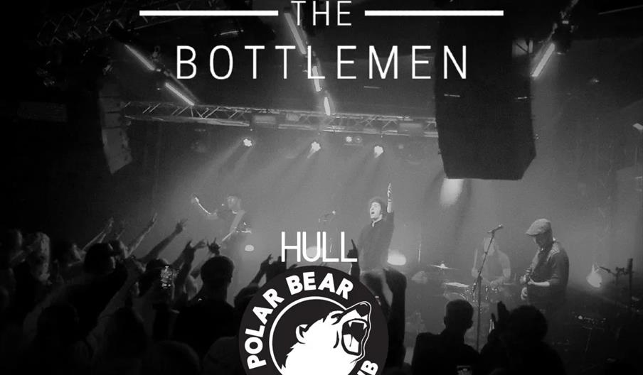 Black and white promotional image showing a live band performing on stage with an audience in the foreground. Text over the image announces "Catfishin