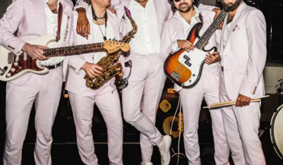 Logo with the word "Rio" in large, elegant gold script, and the words "Music | Bar | Dance" in gold capital letters below.