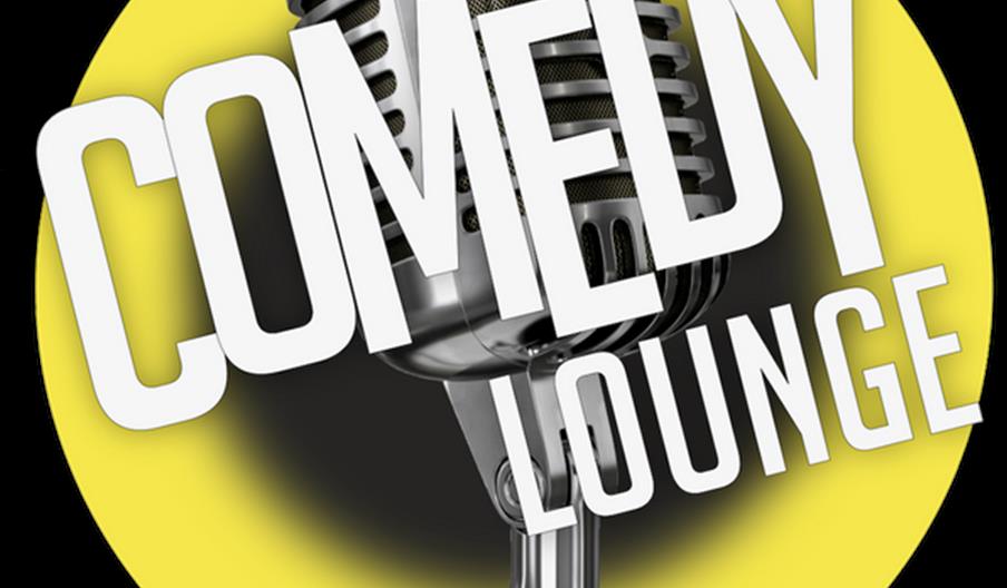 A vintage-style silver microphone is centered in front of a yellow circle, with the words "COMEDY LOUNGE" in bold white letters diagonally across the