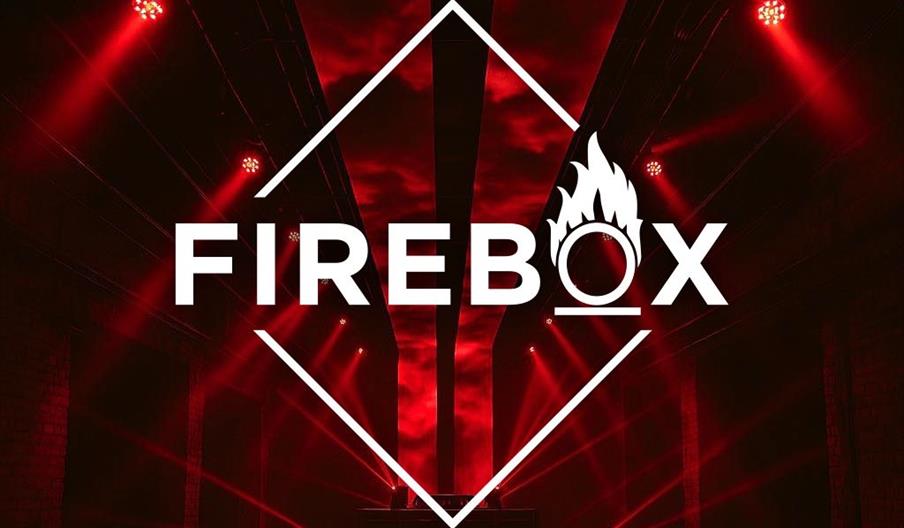 A dark room with dramatic red lighting and beams shining across the space, featuring the word "Firebox" in bold white letters at the center.