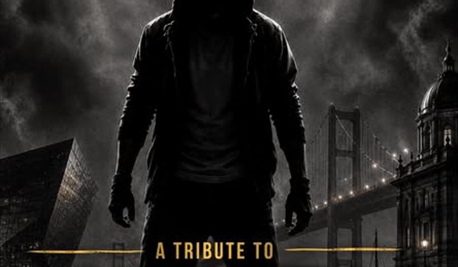 A hooded figure stands in dramatic shadow against a smoky cityscape backdrop with tall buildings and a bridge; text reads "A Tribute to Eminem by Mich