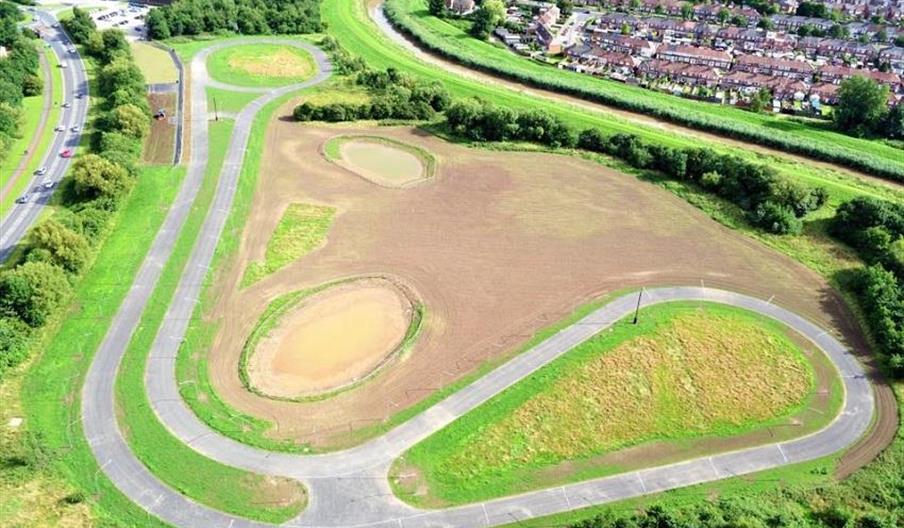 Ennerdale Cycle Circuit pictured from above, a winding cycle circuit with flat grassy plains either side.