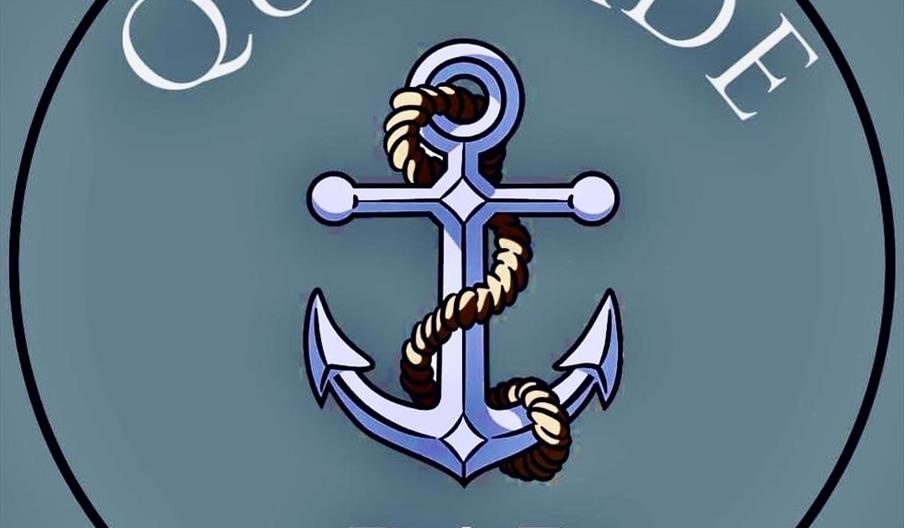 A circular logo featuring a blue anchor wrapped with a rope in the center, with the word "QUAYSIDE" above and "BAR" below, both in white lettering on