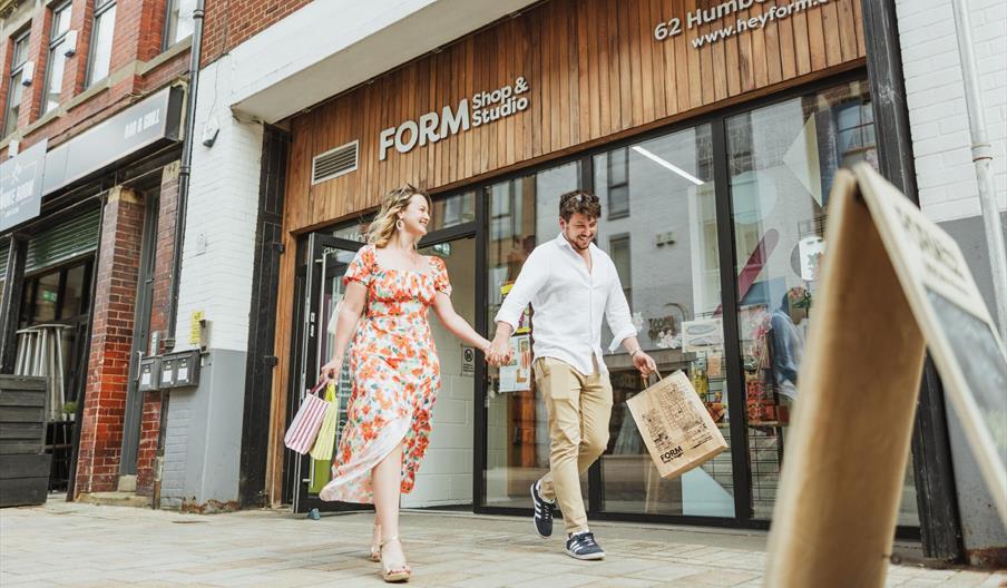 Couple walking hand in hand outside Form Shop & Studio
