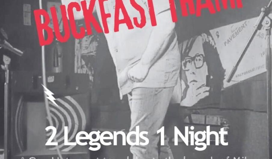 A grayscale event poster features a man holding a microphone on stage. Bold red text at the top reads "Mike Watts" and across the center "Buckfast Tra