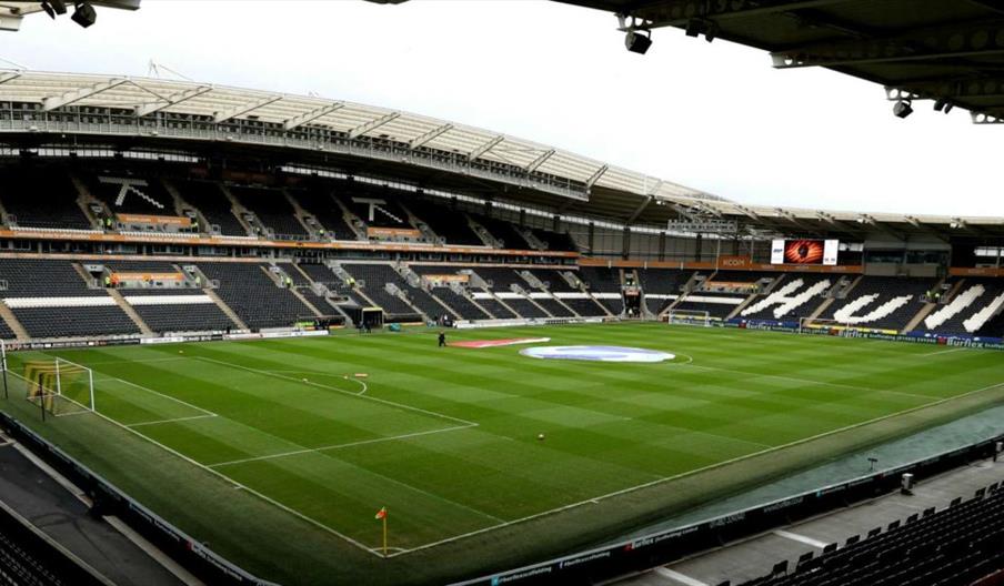 The interior of MKM Stadium in Hull. A football pitch is surrounded by several stands for seating.