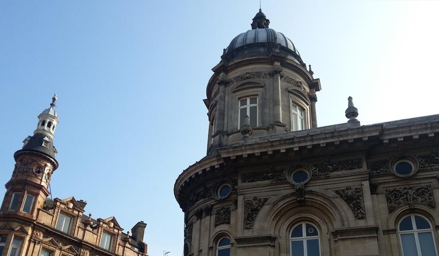 The Hull Maritime Museum building, showing ornate stone architecture and domed towers against a clear blue sky