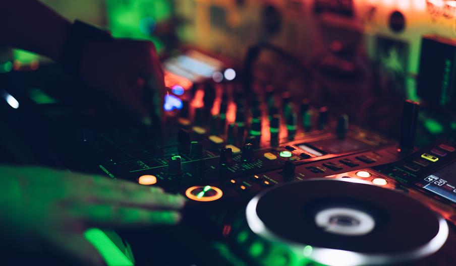 DJ decks with lights and turntables.