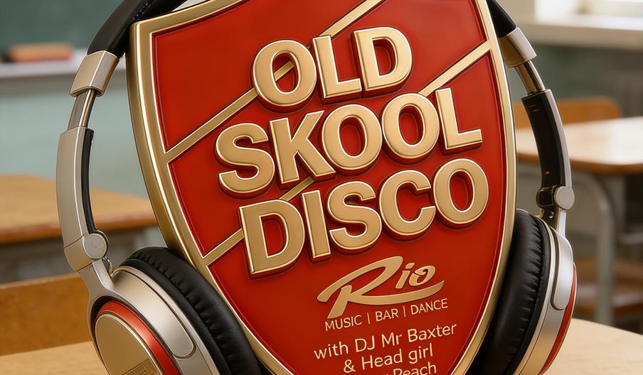 A large red and gold shield-shaped sign reading "Old Skool Disco" is propped up on a school desk, with a pair of retro-style headphones resting on it;