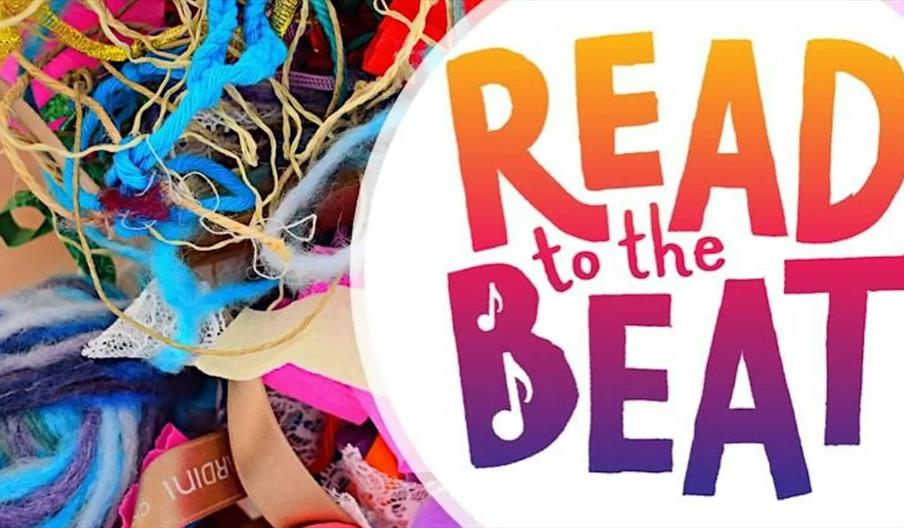 A colorful assortment of textured yarns and ribbons is on the left side of the image, and on the right side, the words "Read to the Beat" are written