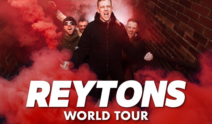 A group of five men stand on outdoor steps surrounded by red smoke, looking excited with one holding a smoke flare; large text in front reads "REYTONS