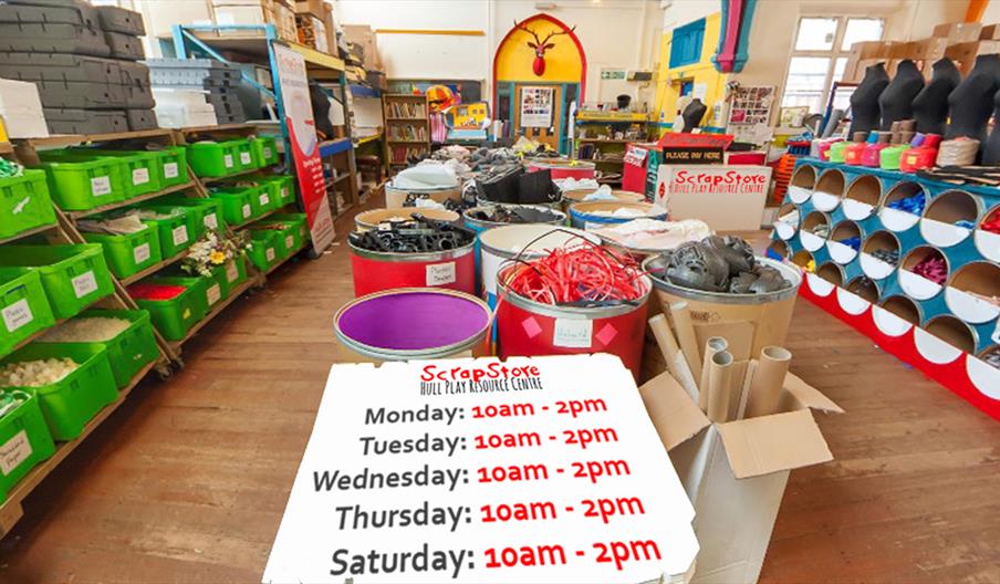 Interior view of a colourful ScarpStore, the craft supply store with shelves of green bins, rolls of fabric, art mannequins, and large barrels of mate