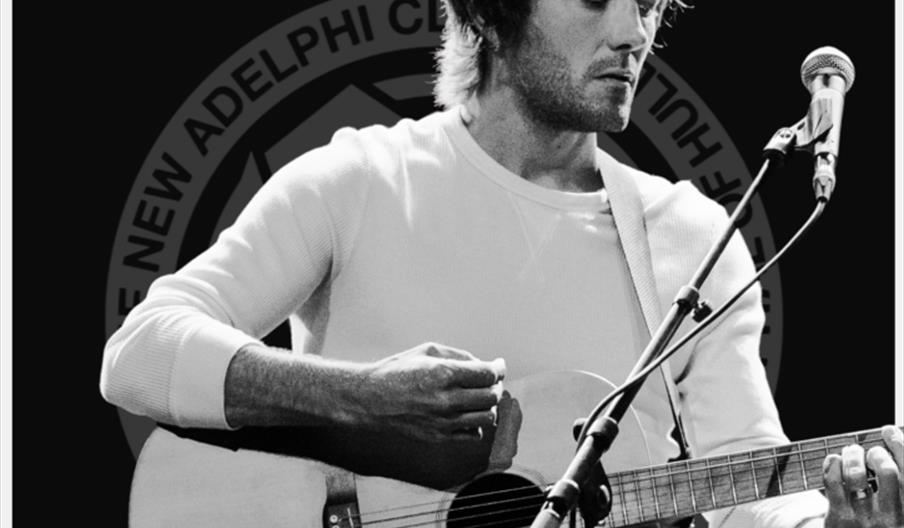 Black and white concert poster featuring Tom Rowley playing an acoustic guitar and singing into a microphone, with large text announcing "Tom Rowley +