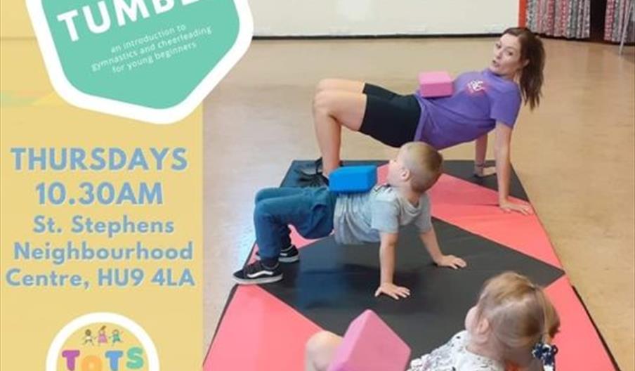 A woman and two young children are on a mat, doing a crab walk exercise with foam blocks balanced on their stomachs. Text on the left advertises "Tots