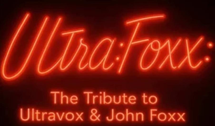 Red neon-style text on a black background reads "Ultra:Foxx: The Tribute to Ultravox & John Foxx."