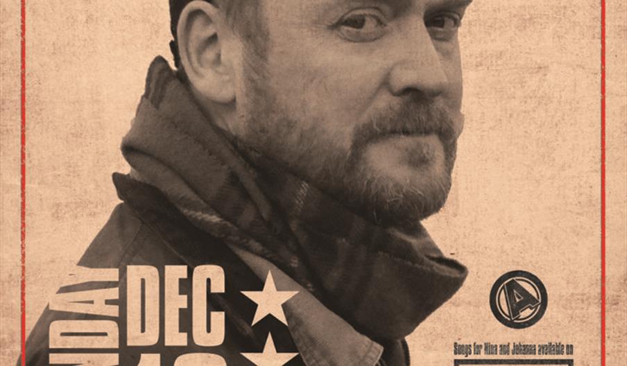 Promotional poster for a James Yorkston concert featuring a sepia-toned photo of a man in outdoor clothing and a cap, with bold red and black text sho