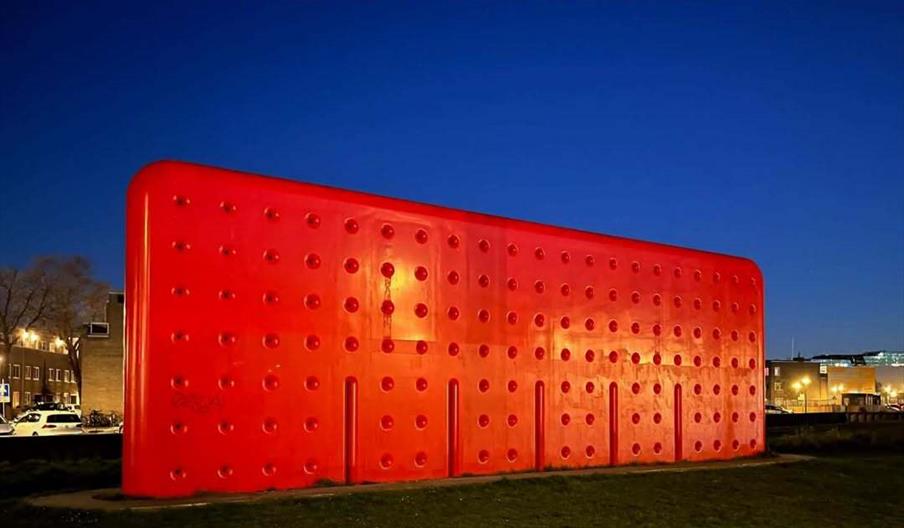 A poster for "Chris Evans Adventures in Modern Music" features a large, red, modern building at dusk with event details: Friday 23rd October, 8pm at T