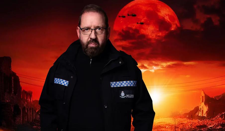 Alfie Moore wearing glasses and a police jacket stands in front of a dramatic, apocalyptic background featuring a large red moon, helicopters, and rui