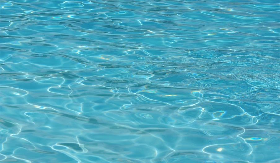 An image of ripples on the surface of a swimming pool.