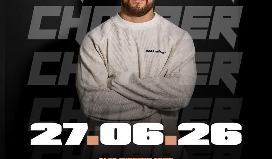 Event poster featuring a man with a beard in a light sweatshirt standing with arms crossed in front of large, bold text reading "CHOPPER." The poster