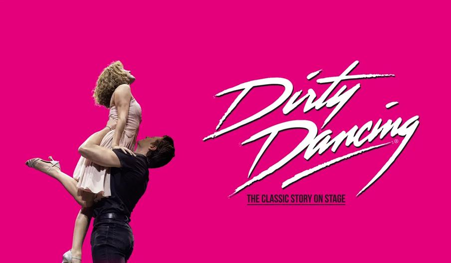A man lifts a woman in a dance pose against a bright pink background, with the text "Dirty Dancing: The Classic Story On Stage" in bold white script t
