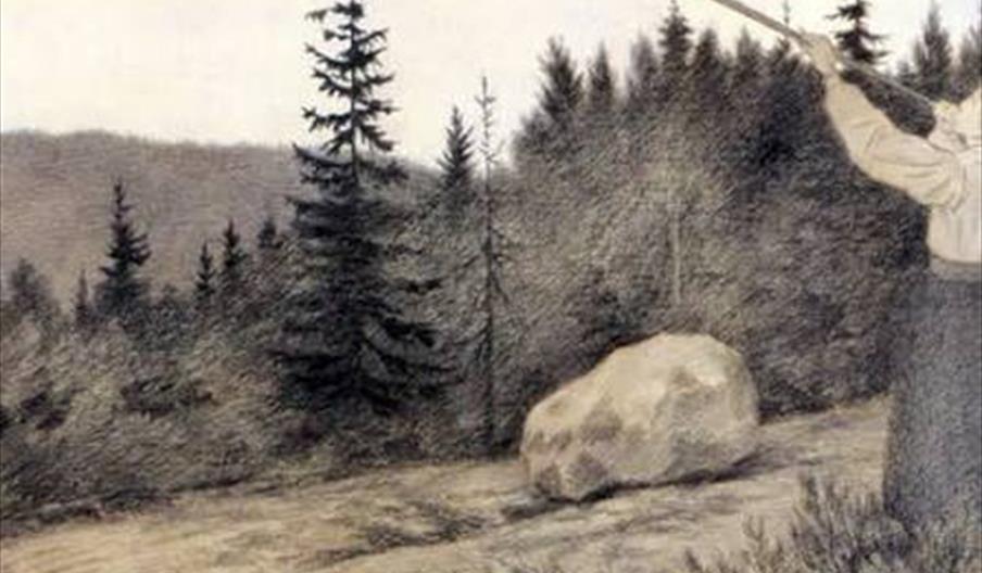 A person standing on a dirt path in a forested area, blowing a long horn, with evergreen trees and a large rock in the background.