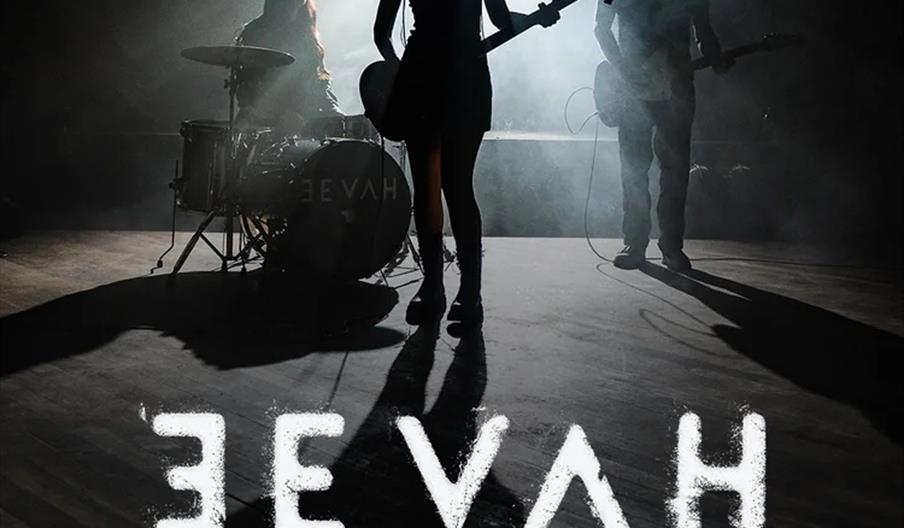 Silhouettes of three band members are shown performing on stage with dramatic backlighting, accompanied by text announcing "EEVAH Independent Venue We