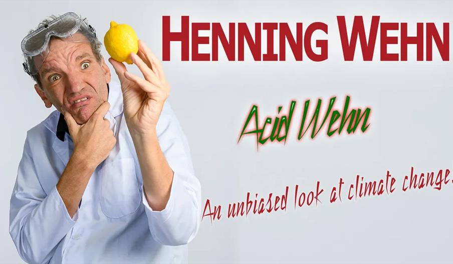 A man in a white lab coat and goggles holds up a lemon with a puzzled expression. The text reads, "HENNING WEHN," "Acid Wehn," and "An unbiased look a