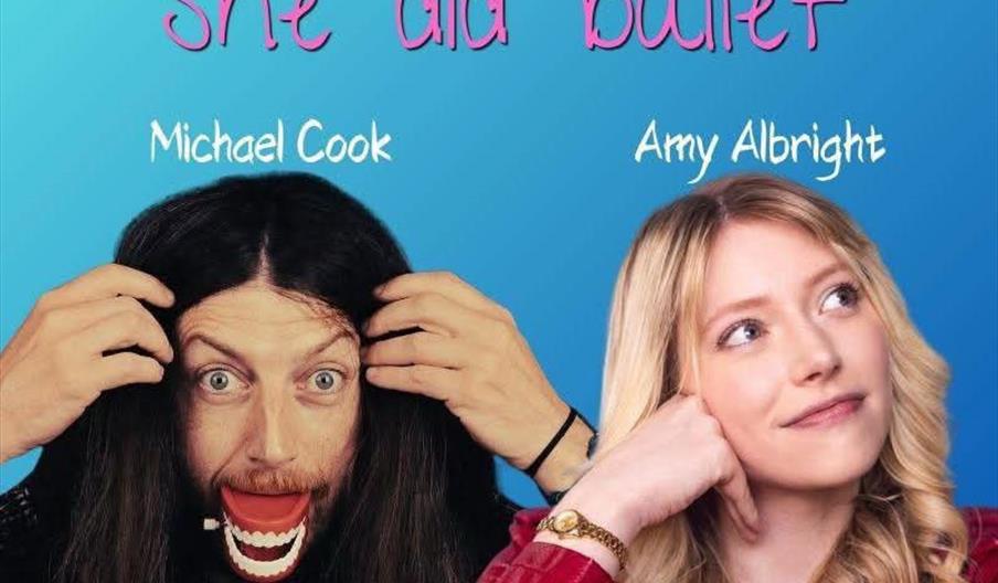A man with long dark hair and a comedic exaggerated mouth expression sits next to a woman with long blonde hair, who rests her chin on her hand and sm